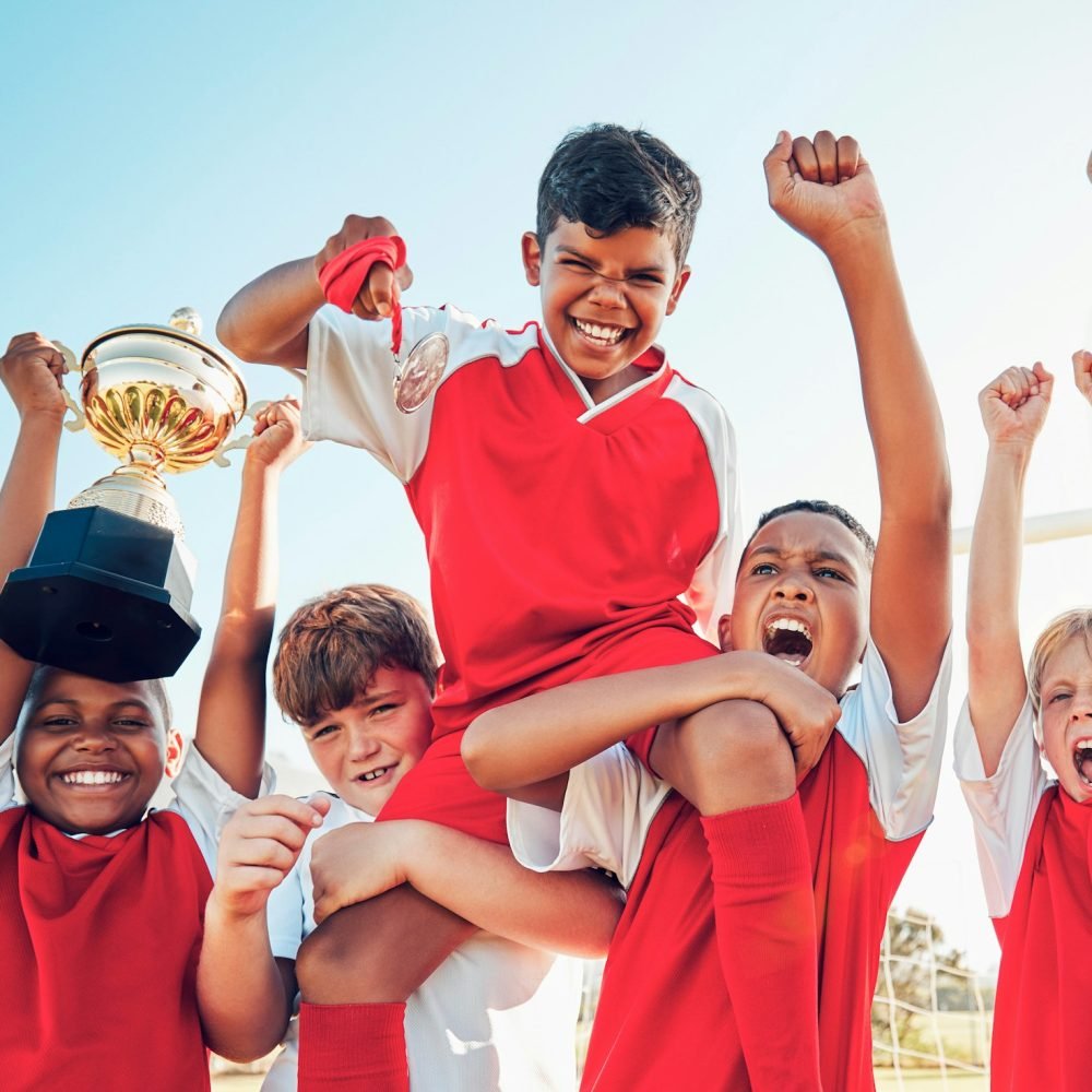 Soccer, celebration and kids team with trophy on soccer field, happy and excited at winning game. S